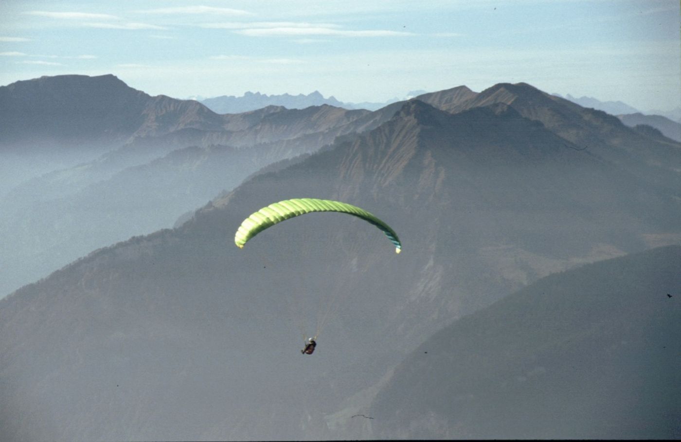 Paraglider above a mountain landscape